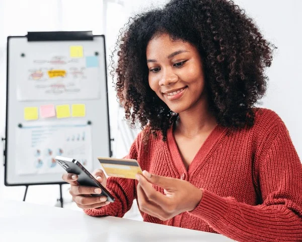 woman smiling while holding credit 600nw 2455321751